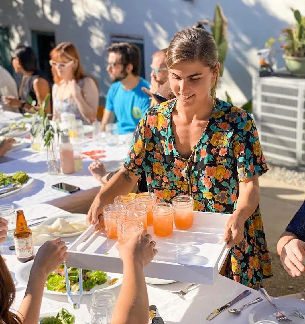 Guests toasting cocktails at golden hour